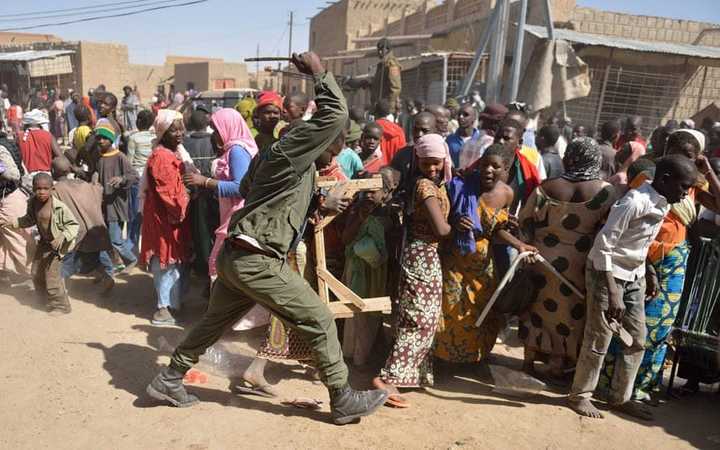 2013年马里安全危机时一名马里士兵正在驱赶人群