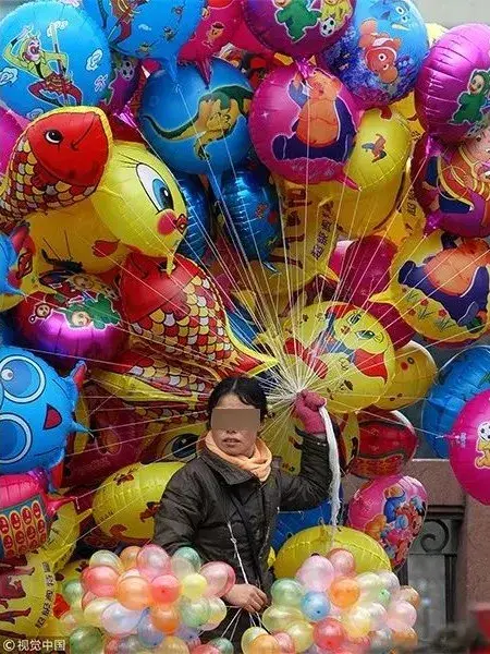 2005年2月9日,一位小贩在贵阳市朝阳桥头出售各种花样的氢气球 视觉