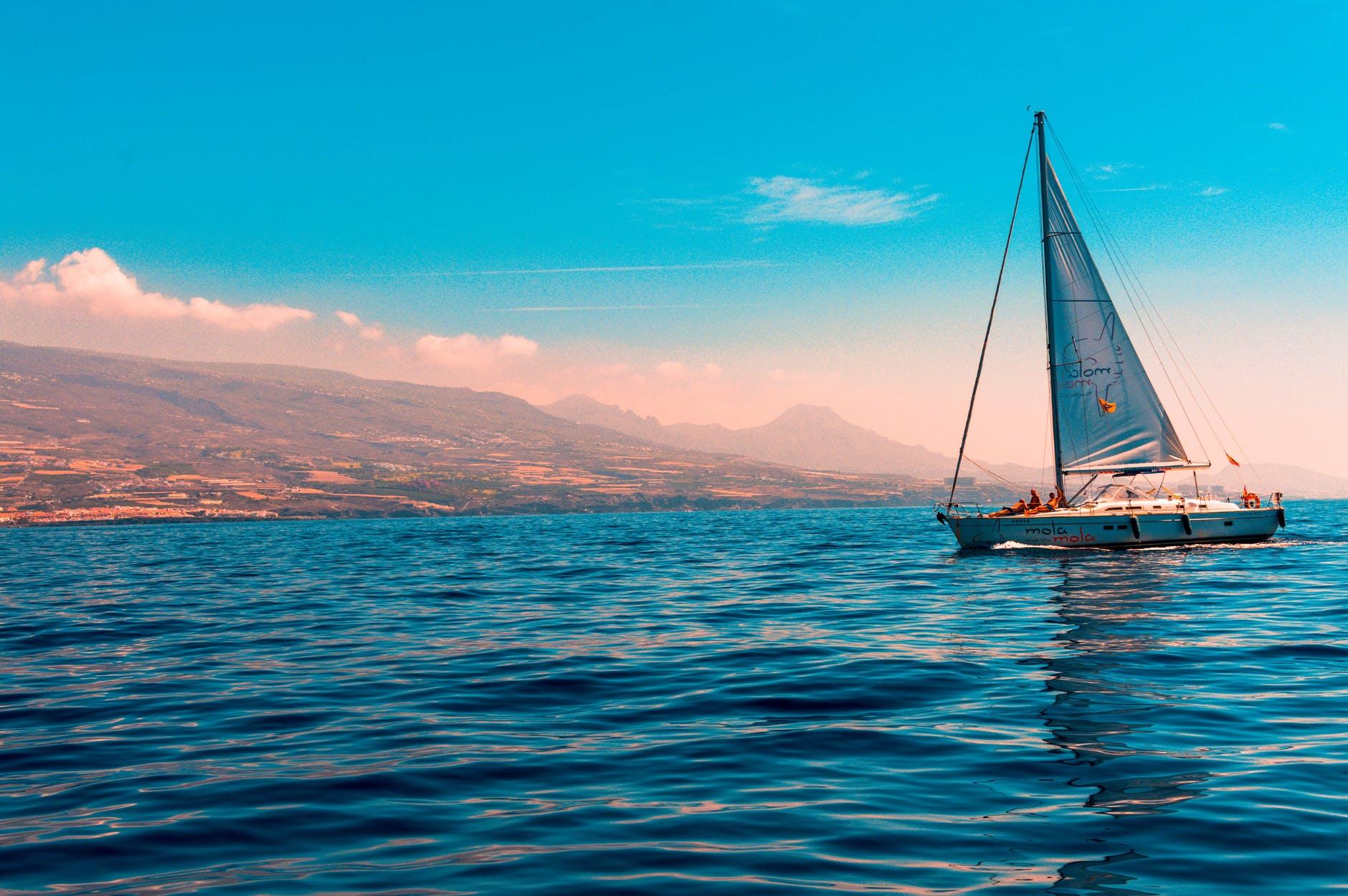 自然风景蓝色海天相接的海面上航行的白色帆船团结进取坚持蓝色大海杨帆起航 - PSD素材网